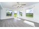 Living room featuring lots of natural light, gray floors, and great backyard views at 15 Bunker Pl, Rotonda West, FL 33947