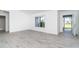 Bright and airy living room with new gray vinyl flooring and plenty of natural light at 15 Bunker Pl, Rotonda West, FL 33947