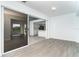 Bright, open living room with sliding glass doors and modern gray flooring at 15 Bunker Pl, Rotonda West, FL 33947