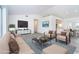 A beautifully staged living room showcases modern furniture, decor, and a seamless connection to the kitchen at 15 Bunker Pl, Rotonda West, FL 33947