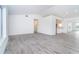 An open-concept living room features neutral walls, wood-look floors and tons of natural light at 15 Bunker Pl, Rotonda West, FL 33947