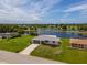 Aerial view showcasing the home's location near a beautiful lake and lush green surroundings at 15 Oakland Hills Pl, Rotonda West, FL 33947