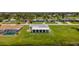 An aerial view of a home highlighting the backyard, neighboring properties and tranquil pond at 15 Oakland Hills Pl, Rotonda West, FL 33947