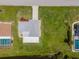 A bird's-eye view captures the home's landscaping, driveway, and proximity to water, showing the neighborhood layout at 15 Oakland Hills Pl, Rotonda West, FL 33947