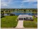 Beautiful waterfront home with mature landscaping and views of a scenic lake and golf course at 15 Oakland Hills Pl, Rotonda West, FL 33947