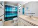 Bathroom featuring a blue-themed shower curtain and a well-lit vanity area at 15 Oakland Hills Pl, Rotonda West, FL 33947