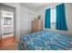 Bedroom featuring bright bedding, a window with curtains, and adjacent bathroom at 15 Oakland Hills Pl, Rotonda West, FL 33947