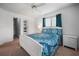 Comfortable bedroom featuring a patterned bedspread, ceiling fan, and well-lit ambiance at 15 Oakland Hills Pl, Rotonda West, FL 33947