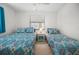 Bedroom with two twin beds, featuring bright bedding and a central nightstand at 15 Oakland Hills Pl, Rotonda West, FL 33947