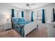 Cozy bedroom with a comfortable bed, ceiling fan, and natural light from two windows at 15 Oakland Hills Pl, Rotonda West, FL 33947