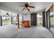 Large bonus room featuring a bar and great views of the lake through sliding glass doors at 15 Oakland Hills Pl, Rotonda West, FL 33947