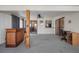 Bright bonus room featuring a bar, lake views, and neutral carpet flooring for comfort at 15 Oakland Hills Pl, Rotonda West, FL 33947