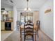 Dining room with dark wood chairs and light fixture, sliding doors to the lanai at 15 Oakland Hills Pl, Rotonda West, FL 33947