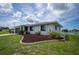 Charming home with a well-manicured front yard, mulch beds and mature landscaping near the water at 15 Oakland Hills Pl, Rotonda West, FL 33947