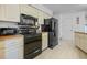 Kitchen with black appliances, wood countertops and white cabinets at 15 Oakland Hills Pl, Rotonda West, FL 33947
