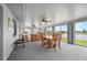 Bright sunroom boasts panoramic views of the lake, with a dining set, and comfortable seating at 15 Oakland Hills Pl, Rotonda West, FL 33947
