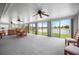 Spacious sunroom offers great lake views, with large windows and a ceiling fan for comfort at 15 Oakland Hills Pl, Rotonda West, FL 33947