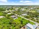 Beautiful aerial view of a house in a lovely neighborhood of homes near a canal at 15521 Lakeland Cir, Port Charlotte, FL 33981