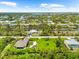 A stunning aerial view of a charming home in a quiet neighborhood of homes on canals at 15521 Lakeland Cir, Port Charlotte, FL 33981