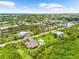 Lovely aerial view of a home in a peaceful neighborhood near a beautiful canal at 15521 Lakeland Cir, Port Charlotte, FL 33981