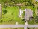 A beautiful home with a large, green, well-manicured lawn and an inviting pool at 15521 Lakeland Cir, Port Charlotte, FL 33981