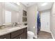 Neutral bathroom featuring granite counters, dark vanity, and shower with curtain at 15521 Lakeland Cir, Port Charlotte, FL 33981