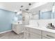 Bright bathroom boasts double vanity, modern lighting, and stylish tile at 15521 Lakeland Cir, Port Charlotte, FL 33981