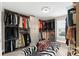 Walk-in closet featuring custom shelving, zebra rug, and lots of natural light at 15521 Lakeland Cir, Port Charlotte, FL 33981