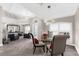 Bright dining room with stylish chandelier, seating, tile floors, and living room in the background at 15521 Lakeland Cir, Port Charlotte, FL 33981