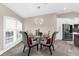 Dining room features a modern chandelier and stylish seating with a view to the kitchen and stainless appliances at 15521 Lakeland Cir, Port Charlotte, FL 33981