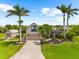 Stunning home with lush landscaping, a well manicured lawn and mature palm trees at 15521 Lakeland Cir, Port Charlotte, FL 33981