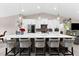 Island kitchen featuring pendant lighting, stainless appliances, white cabinetry and breakfast bar seating at 15521 Lakeland Cir, Port Charlotte, FL 33981