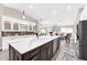 Modern kitchen island features stainless steel appliances, quartz countertops, and pendant lighting at 15521 Lakeland Cir, Port Charlotte, FL 33981