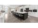 Modern kitchen featuring a large island with seating, quartz countertops, and stainless steel appliances at 15521 Lakeland Cir, Port Charlotte, FL 33981