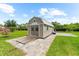 Exterior view of shed with patio and landscaping at 15521 Lakeland Cir, Port Charlotte, FL 33981