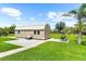 Exterior view of shed with patio, landscaping and swing at 15521 Lakeland Cir, Port Charlotte, FL 33981