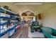 Interior view of shed with wood floors, shelving and yard equipment at 15521 Lakeland Cir, Port Charlotte, FL 33981