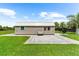 Exterior view of shed with patio, landscaping and swing at 15521 Lakeland Cir, Port Charlotte, FL 33981