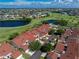 Aerial view of white and red roof condos in a beautiful golf community on a sunny day at 1640 Atares # 23, Punta Gorda, FL 33950