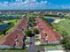 Aerial view of the golf course community villa with a tile roof and lush landscaping at 1640 Atares # 23, Punta Gorda, FL 33950