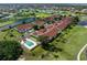 Stunning aerial view of homes with a pool and golf course in a beautifully landscaped community at 1640 Atares # 23, Punta Gorda, FL 33950