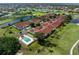 Overhead view of townhomes with a community pool, surrounded by a golf course and a large lake at 1640 Atares # 23, Punta Gorda, FL 33950