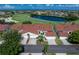 Aerial view of white and red roof condos next to a pond and golf course on a sunny day at 1640 Atares # 23, Punta Gorda, FL 33950