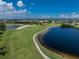 Aerial view of a golf course and lake showcasing the peaceful scenery in this picturesque community at 1640 Atares # 23, Punta Gorda, FL 33950