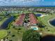 Aerial view of the golf community with beautiful lakes, lush greens, and a swimming pool at 1640 Atares # 23, Punta Gorda, FL 33950
