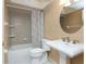 Bathroom featuring a pedestal sink, a shower/tub, and a white tiled floor at 1640 Atares # 23, Punta Gorda, FL 33950