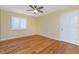 Bright bedroom with wood floors, ceiling fan, and shuttered window at 1640 Atares # 23, Punta Gorda, FL 33950
