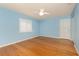 Bright bedroom with light blue walls, wood floors, and a white ceiling fan at 1640 Atares # 23, Punta Gorda, FL 33950