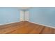 A spacious bedroom with light blue walls, wood floors, a closet and a doorway at 1640 Atares # 23, Punta Gorda, FL 33950