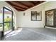 A covered, tiled entryway with an arched opening and security screen door, leading into the home at 1640 Atares # 23, Punta Gorda, FL 33950